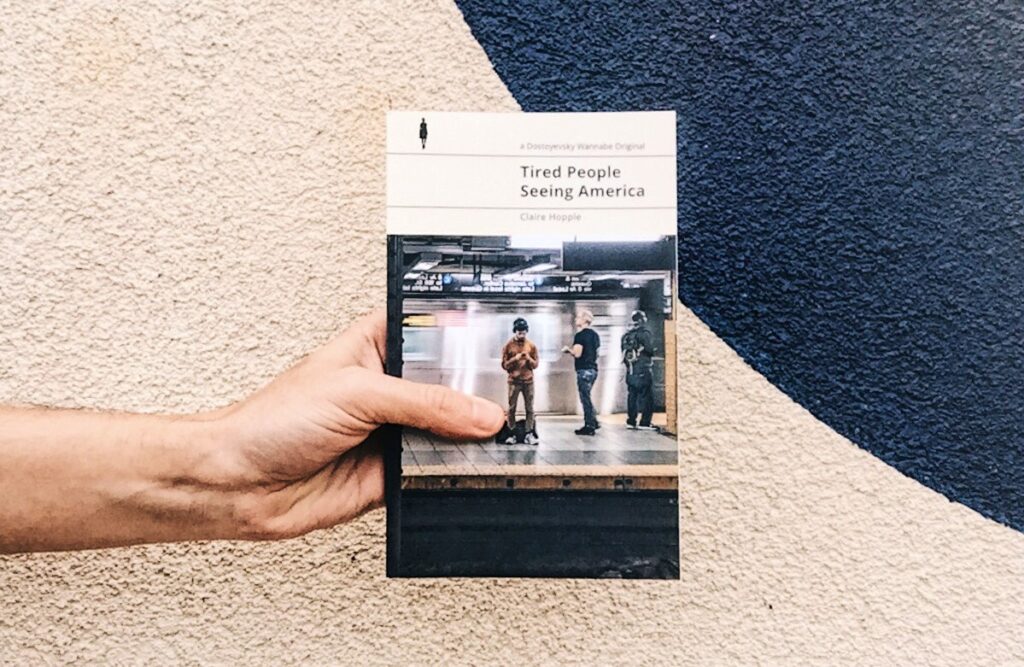 This is a paperback photo of Tired People Seeing America by Claire Hopple