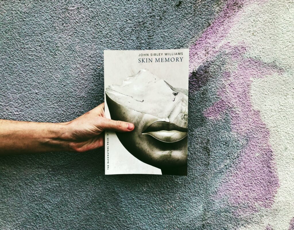 This is a paperback photo of Skin Memory by John Sibley Williams from University of Nebraska Press